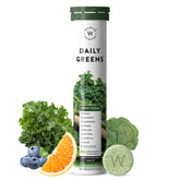 Wellbeing Nutrition Daily Greens tube and green tablet with kale broccoli fruit garnish wholefood multivitamin with superfoods
